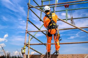 Industrial worker on scaffolding at outside jobsite