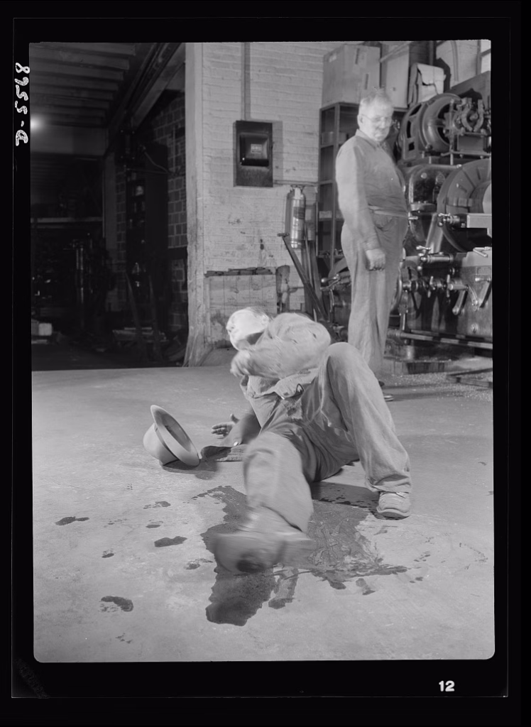 In a picture from 1942, a worker has slipped due to oil on the ground.